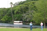 Ronnie Ray teaches as a boat passes behind