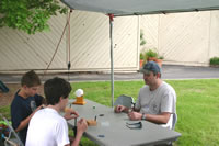 Brian Watson Helps two students tie a fly